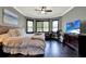 Main bedroom featuring a seating area, bay windows, dark hardwood floors, and an exercise bike at 955 Holly Springs Ter, Oviedo, FL 32765