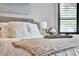 Main bedroom showcasing cozy decor, plantation shutters, and a luxurious bed with decorative pillows at 955 Holly Springs Ter, Oviedo, FL 32765