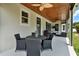 Covered patio with outdoor dining table, seating area, and a wood plank ceiling at 955 Holly Springs Ter, Oviedo, FL 32765