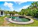 Inviting lagoon-style pool with tropical landscaping and tranquil water features, ideal for relaxation and outdoor entertainment at 955 Holly Springs Ter, Oviedo, FL 32765