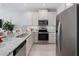 Modern kitchen featuring stainless steel appliances, granite countertops, and ample cabinet space at 9972 Red Canoe Aly, Orlando, FL 32832