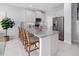 Spacious kitchen with white cabinets, granite countertops, and stainless steel appliances at 9972 Red Canoe Aly, Orlando, FL 32832