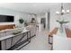 Open-concept living room with modern furnishings, flowing into the kitchen and dining area at 9972 Red Canoe Aly, Orlando, FL 32832