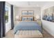 Cozy bedroom featuring blue accents, soft lighting, carpeted floors, and decorative wall art at 9980 Red Canoe Aly, Orlando, FL 32832