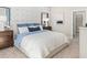 Well-lit bedroom featuring blue accents, patterned wallpaper, carpeted floors, and a glimpse into the closet at 9980 Red Canoe Aly, Orlando, FL 32832