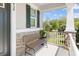 Charming front porch with stone accents, a dark door, a bench, and a view of the neighborhood at 9980 Red Canoe Aly, Orlando, FL 32832