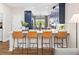 Contemporary kitchen with bar stool seating, quartz countertops, and views into the dining area at 9980 Red Canoe Aly, Orlando, FL 32832