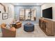 A cozy living room featuring mirrors, soft seating, a flat-screen tv and carpeted floors at 9980 Red Canoe Aly, Orlando, FL 32832