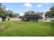 Spacious backyard with screened pool, shed, and ample lawn area, perfect for outdoor activities at 1006 Hanging Vine Pt, Longwood, FL 32750