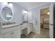 Bright bathroom featuring double sinks, granite counters, and tile floors, connecting to the bedroom at 1006 Hanging Vine Pt, Longwood, FL 32750