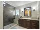 Modern bathroom featuring a glass enclosed shower, granite vanity, and updated fixtures at 1006 Hanging Vine Pt, Longwood, FL 32750