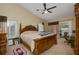 Well-lit bedroom featuring carpet flooring, a ceiling fan, and sliding glass door leading to the outdoors at 1006 Hanging Vine Pt, Longwood, FL 32750