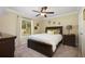 Cozy bedroom with a ceiling fan, carpet flooring, and a window view with lots of natural light at 1006 Hanging Vine Pt, Longwood, FL 32750