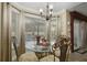 Charming breakfast nook features a glass table, bay window, and decorative chandelier at 1006 Hanging Vine Pt, Longwood, FL 32750