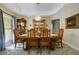 Elegant dining room with a tray ceiling, chandelier, and wood furniture at 1006 Hanging Vine Pt, Longwood, FL 32750