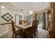 Charming dining area featuring a wooden table, chandelier, and views into the living space at 1006 Hanging Vine Pt, Longwood, FL 32750