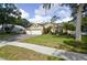Beautiful single-story home featuring a three-car garage, mature trees, and a well-manicured lawn at 1006 Hanging Vine Pt, Longwood, FL 32750