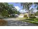 Inviting single-story home with a three-car garage, mature trees, and charming curb appeal at 1006 Hanging Vine Pt, Longwood, FL 32750