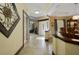 Open foyer leading to dining and living areas, showcasing tile flooring and natural light at 1006 Hanging Vine Pt, Longwood, FL 32750