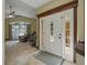 Inviting foyer with a tiled floor, decorative front door, and views into the living room at 1006 Hanging Vine Pt, Longwood, FL 32750
