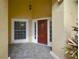 Welcoming front entrance featuring a red door, sidelights, and brick-paved porch at 1006 Hanging Vine Pt, Longwood, FL 32750