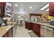 Elegant kitchen features granite countertops, modern appliances, and an adjacent dining area at 1006 Hanging Vine Pt, Longwood, FL 32750