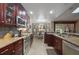 Spacious kitchen features dark wood cabinetry, stainless appliances, and adjacent breakfast nook at 1006 Hanging Vine Pt, Longwood, FL 32750