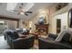 Open living room features a fireplace, vaulted ceiling, and comfortable leather seating at 1006 Hanging Vine Pt, Longwood, FL 32750