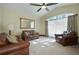 Bright living room featuring a large window, comfortable seating, and a neutral color palette at 1006 Hanging Vine Pt, Longwood, FL 32750
