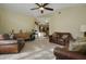 Cozy living room with carpet, ceiling fan, and comfortable leather seating at 1006 Hanging Vine Pt, Longwood, FL 32750