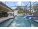 A relaxing screened-in pool with a waterfall feature offers a backyard retreat at 1006 Hanging Vine Pt, Longwood, FL 32750