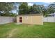 Yellow backyard shed with a red door provides extra storage space at 1006 Hanging Vine Pt, Longwood, FL 32750