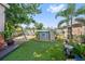 Backyard featuring an above ground pool, swing set and lush landscaping, creating an ideal outdoor oasis at 12137 Buttonbush Loop, Leesburg, FL 34788