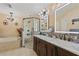 Well-appointed bathroom featuring double sinks, a large soaking tub, and a glass-enclosed shower at 12137 Buttonbush Loop, Leesburg, FL 34788