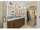 Bathroom with double sink vanity with ample storage, tile backsplash, and decorative lighting at 12137 Buttonbush Loop, Leesburg, FL 34788