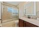 Bathroom featuring tub, sink with a granite countertop, stylish fixtures, and a frosted glass shower door at 12137 Buttonbush Loop, Leesburg, FL 34788