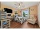 Charming bedroom with a murphy bed, ceiling fan, desk and work space, and bright natural light at 12137 Buttonbush Loop, Leesburg, FL 34788