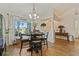 Inviting dining room with wood-look floors, natural light, and views of outdoor seating at 12137 Buttonbush Loop, Leesburg, FL 34788