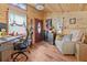 Inviting -shed workspace with rustic wood paneling, cozy seating and practical desk area at 12137 Buttonbush Loop, Leesburg, FL 34788