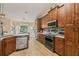 Beautiful kitchen with custom wood cabinets, granite countertops, and stainless steel appliances at 12137 Buttonbush Loop, Leesburg, FL 34788