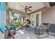 Inviting porch with wicker rocking chairs and views of the backyard, perfect for relaxing outdoors at 12137 Buttonbush Loop, Leesburg, FL 34788