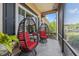 Relaxing screened porch featuring comfortable egg chairs and a view of the outdoors at 12137 Buttonbush Loop, Leesburg, FL 34788