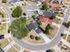 Aerial view of a home with mature trees and circular driveway in a neighborhood at 181 Pinewood Cir, Kissimmee, FL 34743
