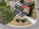 Aerial view of a home with a dark roof, a long driveway, and mature landscaping at 181 Pinewood Cir, Kissimmee, FL 34743