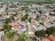 Wide aerial shot of homes with yards and lawns in a neighborhood near a pond at 181 Pinewood Cir, Kissimmee, FL 34743