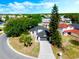 Aerial view of a beautiful home featuring mature trees and long driveway at 181 Pinewood Cir, Kissimmee, FL 34743