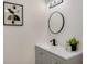 Stylish bathroom featuring a modern vanity with a black faucet, mirror and decor at 181 Pinewood Cir, Kissimmee, FL 34743