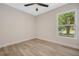 Bright, empty bedroom with new floors and ceiling fan at 181 Pinewood Cir, Kissimmee, FL 34743