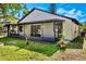 Well-maintained home exterior featuring a screened porch and neutral siding at 181 Pinewood Cir, Kissimmee, FL 34743