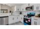 Well-lit kitchen boasting white cabinets, modern appliances, and sleek countertops at 181 Pinewood Cir, Kissimmee, FL 34743